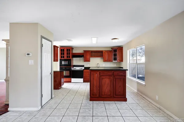 a kitchen with stainless steel appliances granite countertop a stove a sink dishwasher and a microwave oven with cabinets