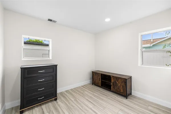 a view of a room with wooden floor