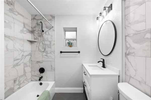 a bathroom with a bathtub and shower