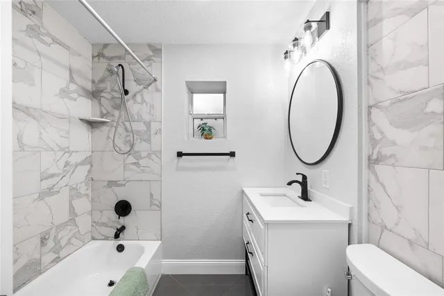 a bathroom with a bathtub and shower