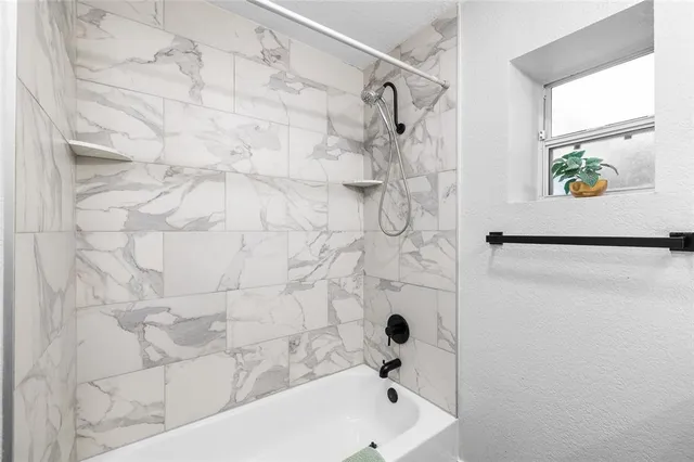 a view of a livingroom with workspace and a window