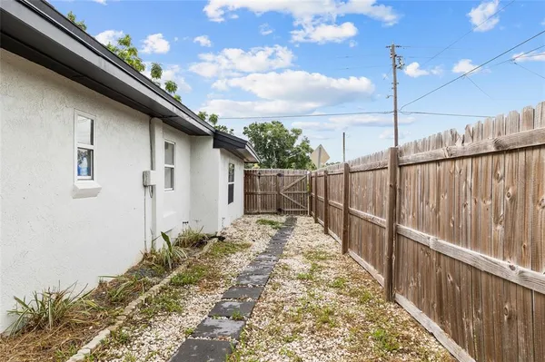 a backyard of a house with table and chairs