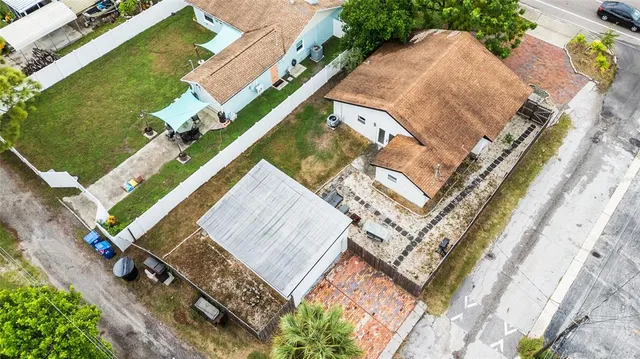 an aerial view of residential house with outdoor space and swimming pool