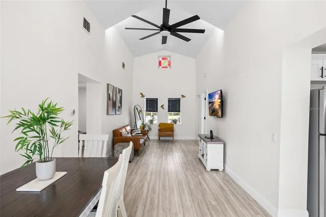 a kitchen with white cabinets stainless steel appliances and a refrigerator