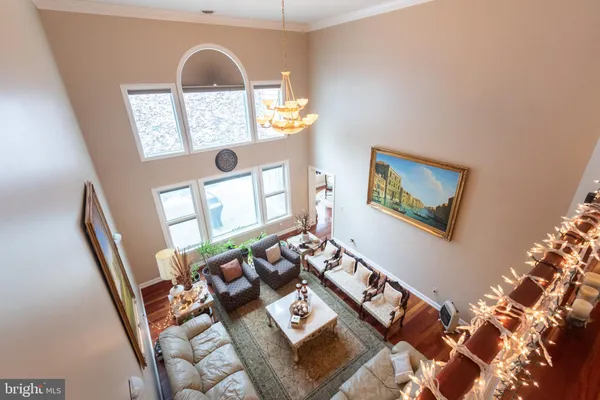 a view of a hallway with wooden floor and furniture
