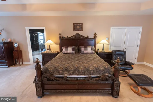 a spacious bedroom with a bed and a couch