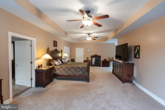 a bathroom with a granite countertop sink toilet mirror and shower