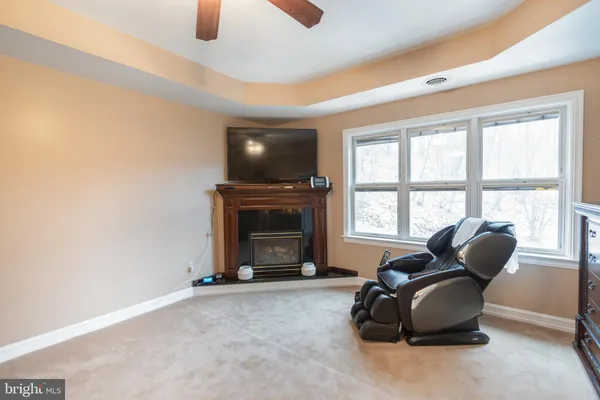 a view of a hallway and a livingroom with furniture