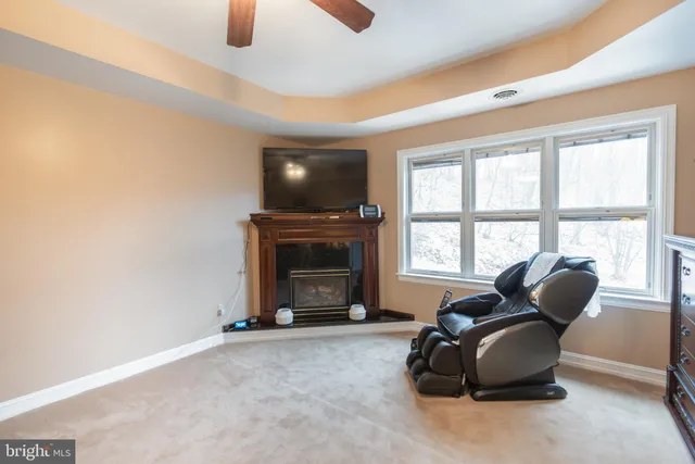 a view of a hallway and a livingroom with furniture