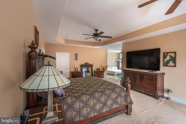 a view of a hallway with wooden floor and furniture