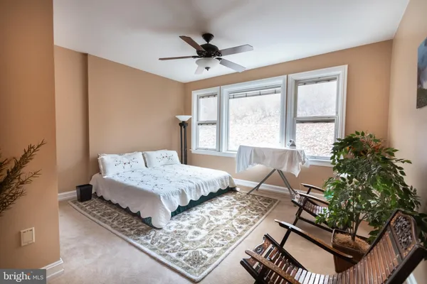 a living room with furniture a rug and a table