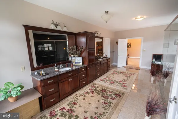 a white house that has a tree in front of it