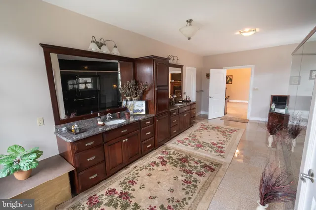 a white house that has a tree in front of it