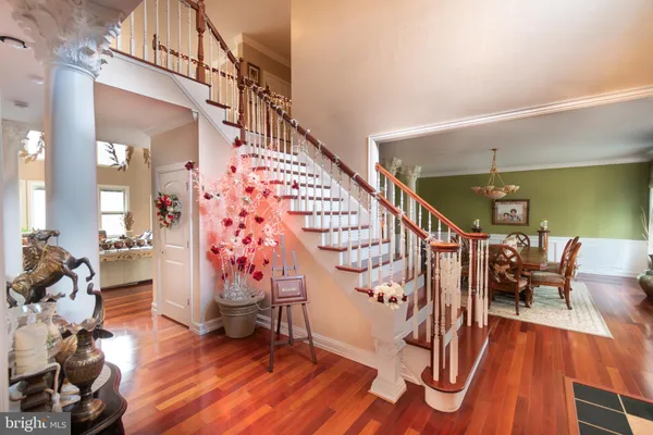 a view of entryway with wooden floor and stairs