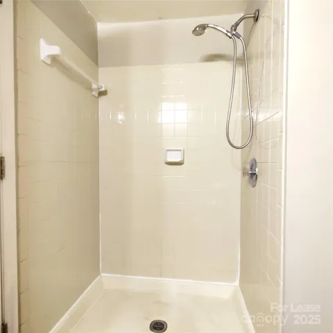 a bathroom with a glass shower door