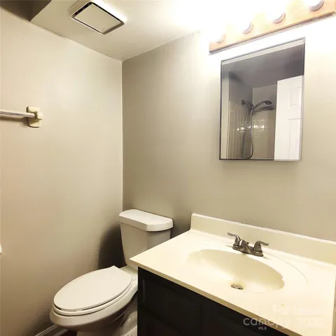 a white toilet sitting next to a bathroom sink