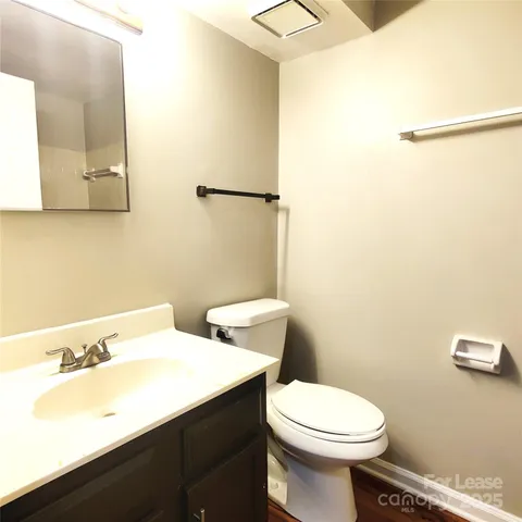 a bathroom with a sink a toilet and mirror