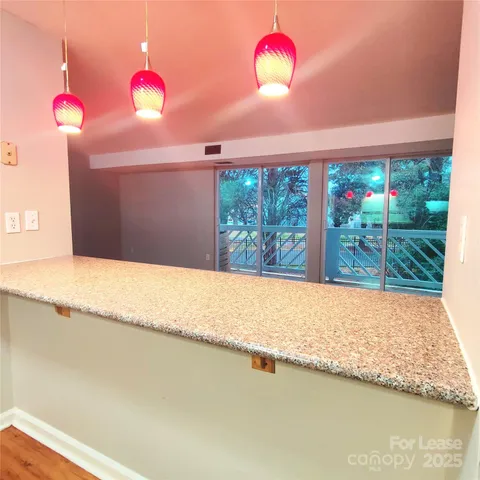 a view of a room with a window and ceiling fan