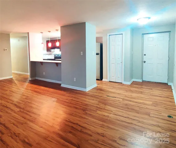 a view of a room with wooden floor and cabinet