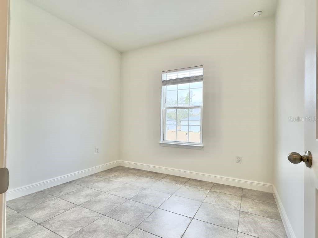 15885 Southwest 35th Court Road, Unit 2 Ocala, FL 34473 - Photo 12 of 21 an empty room with windows