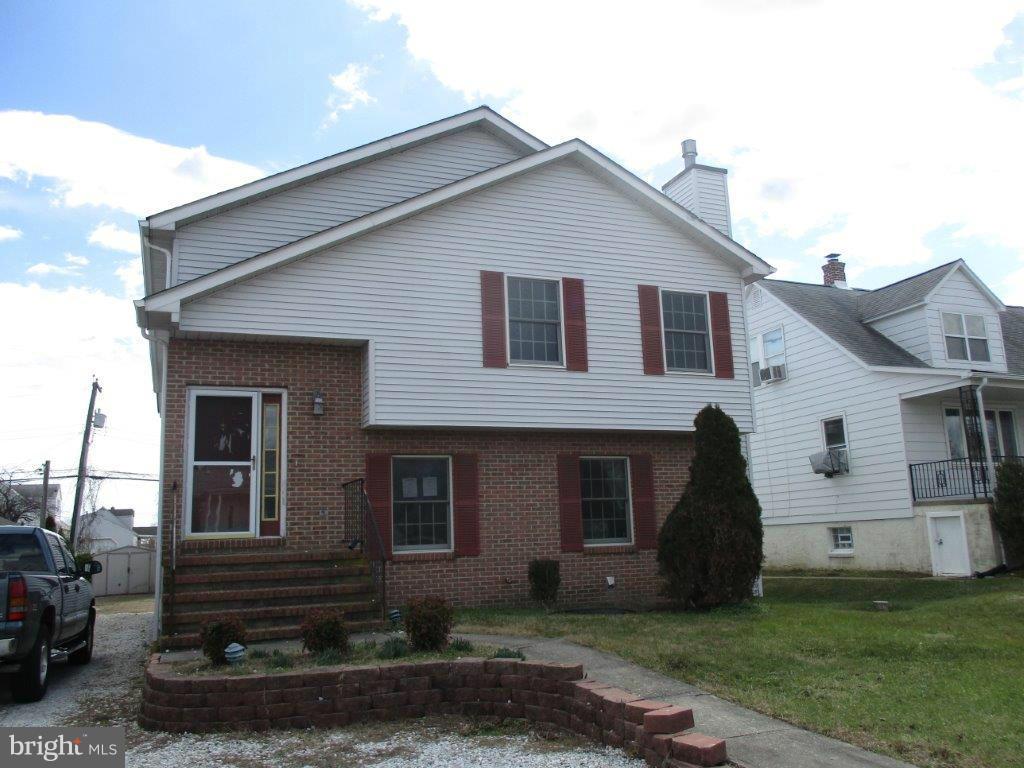 3223 Lynch Road Baltimore, MD 21219 - Photo 1 of 15 a front view of a house with a yard
