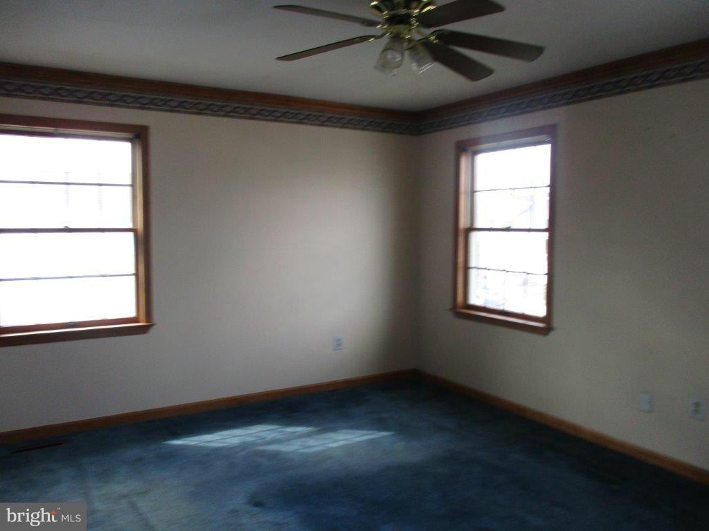 3223 Lynch Road Baltimore, MD 21219 - Photo 11 of 15 an empty room with a window and a fan