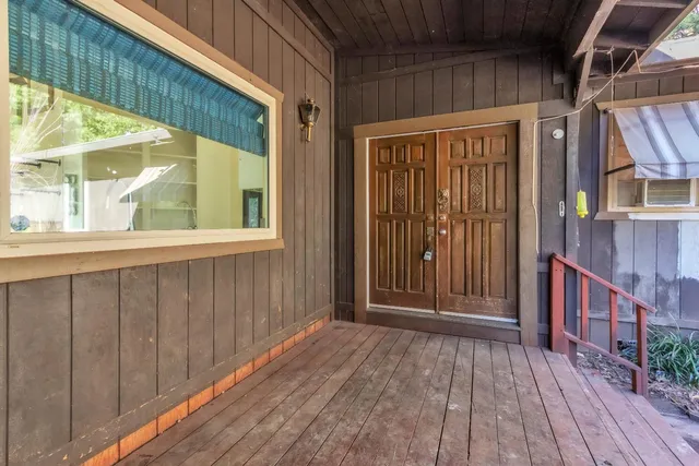 a view of a house with deck and wooden floor