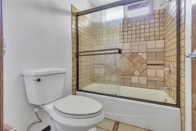 a bathroom with a shower and a toilet