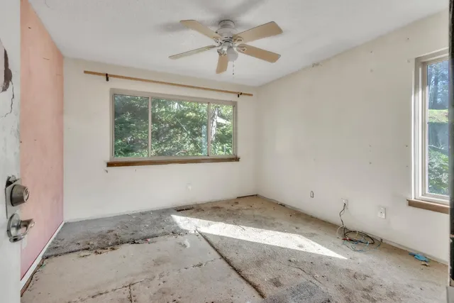a view of a livingroom with a window and a ceiling fan