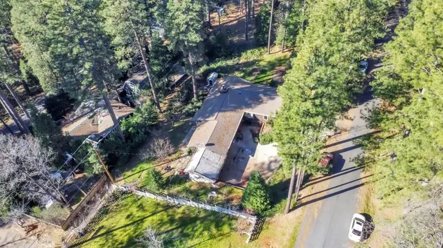 an aerial view of a house with a yard and garden