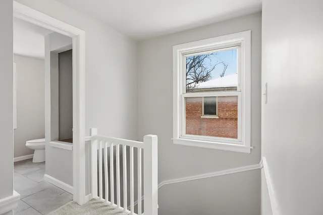 a bathroom with a toilet and a window