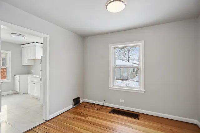 a view of a room with wooden floor and windows