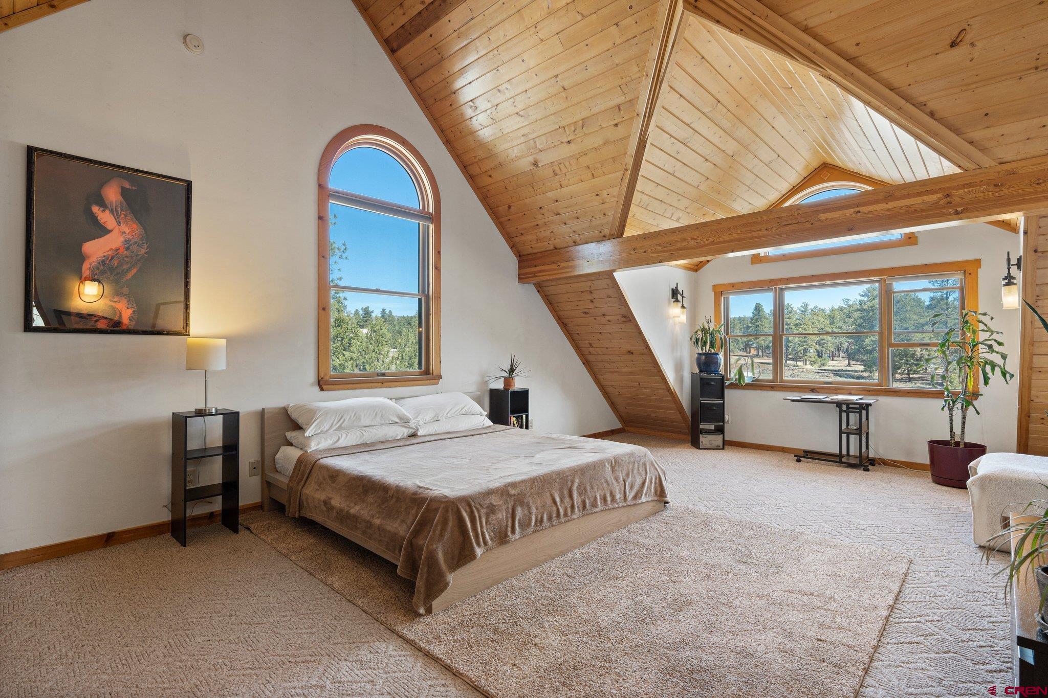 32 Meadows Road Durango, CO 81301 - Photo 18 of 35 a spacious bedroom with a bed and a large window