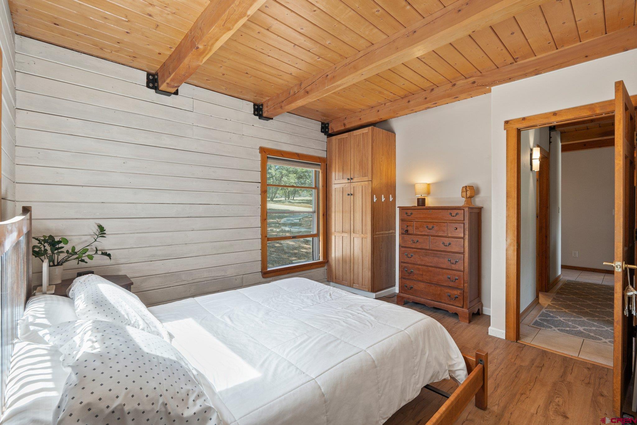 32 Meadows Road Durango, CO 81301 - Photo 24 of 35 a bedroom with a bed and a chandelier