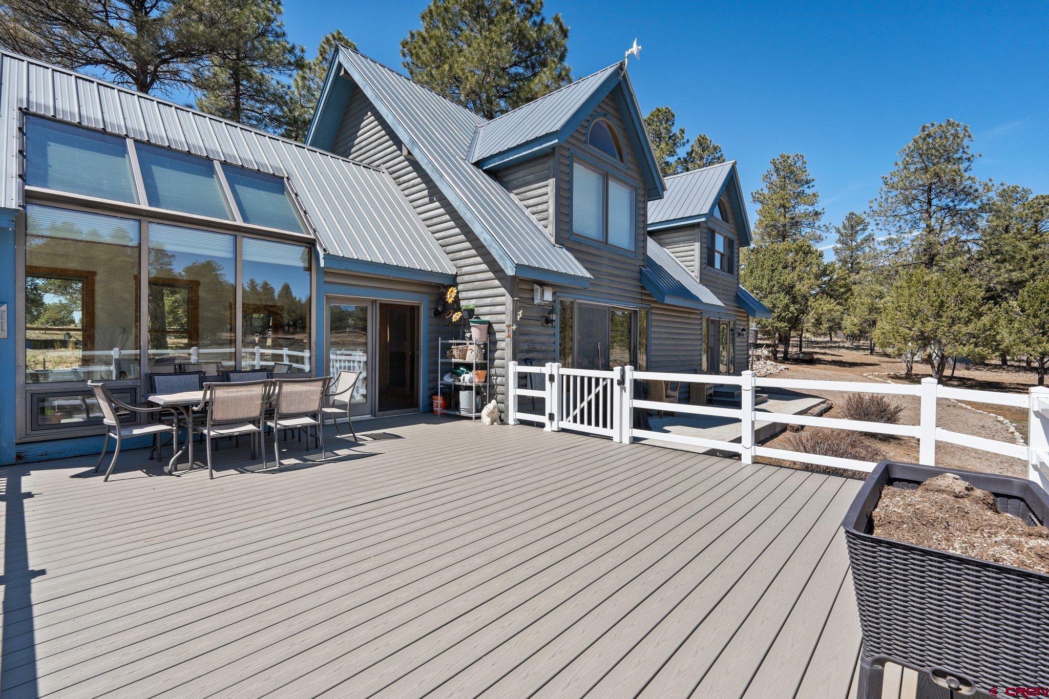 32 Meadows Road Durango, CO 81301 - Photo 27 of 35 a view of a house with wooden deck and outdoor seating