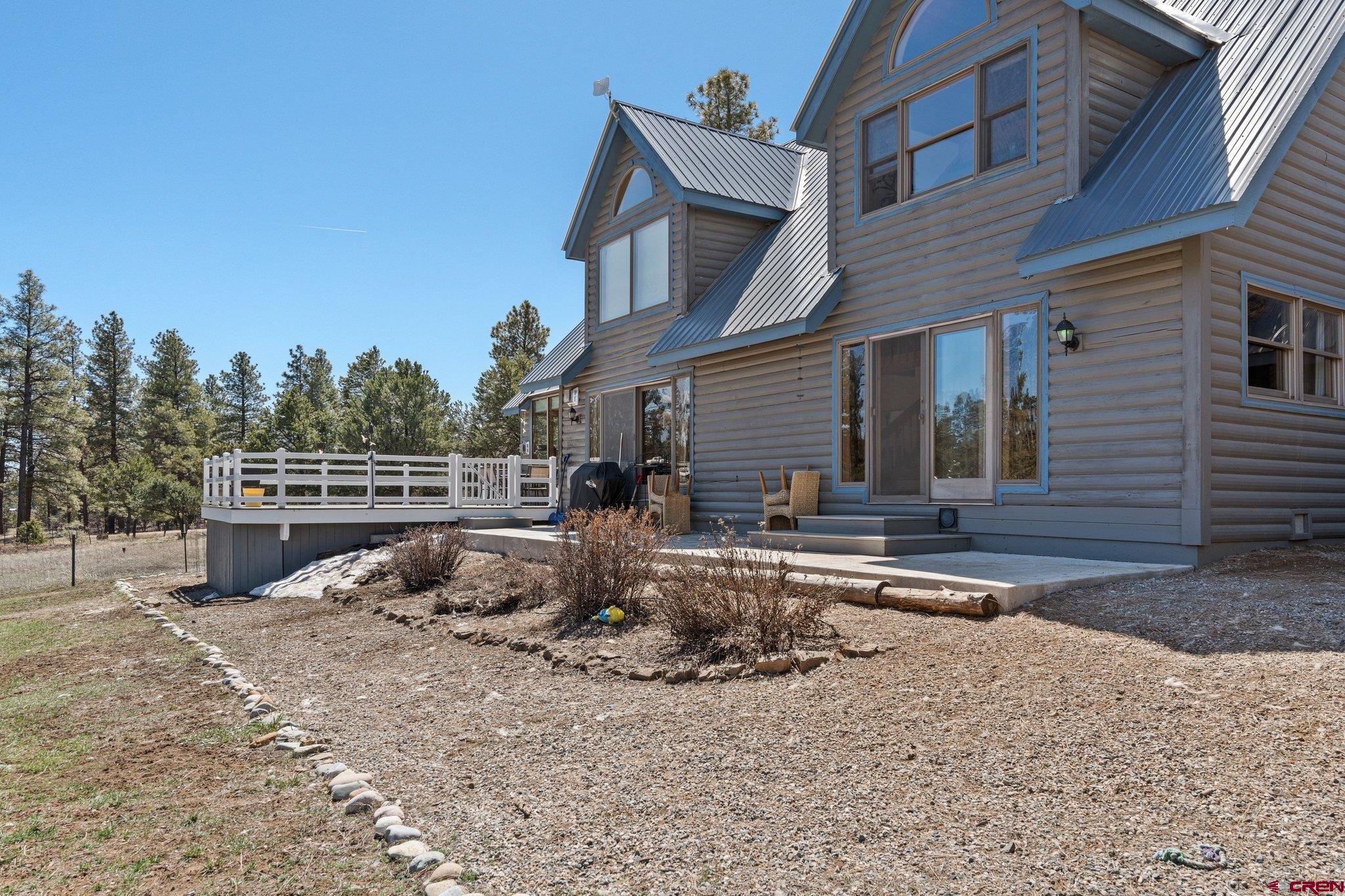 32 Meadows Road Durango, CO 81301 - Photo 28 of 35 a backyard of a house with barbeque oven and outdoor seating