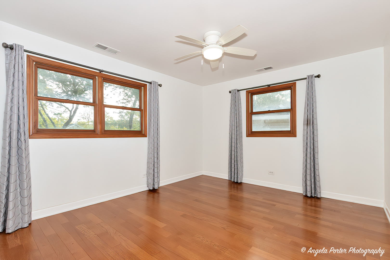 7 Manor Road Lake Zurich, IL 60047 - Photo 17 of 27 an empty room with wooden floor fan and windows