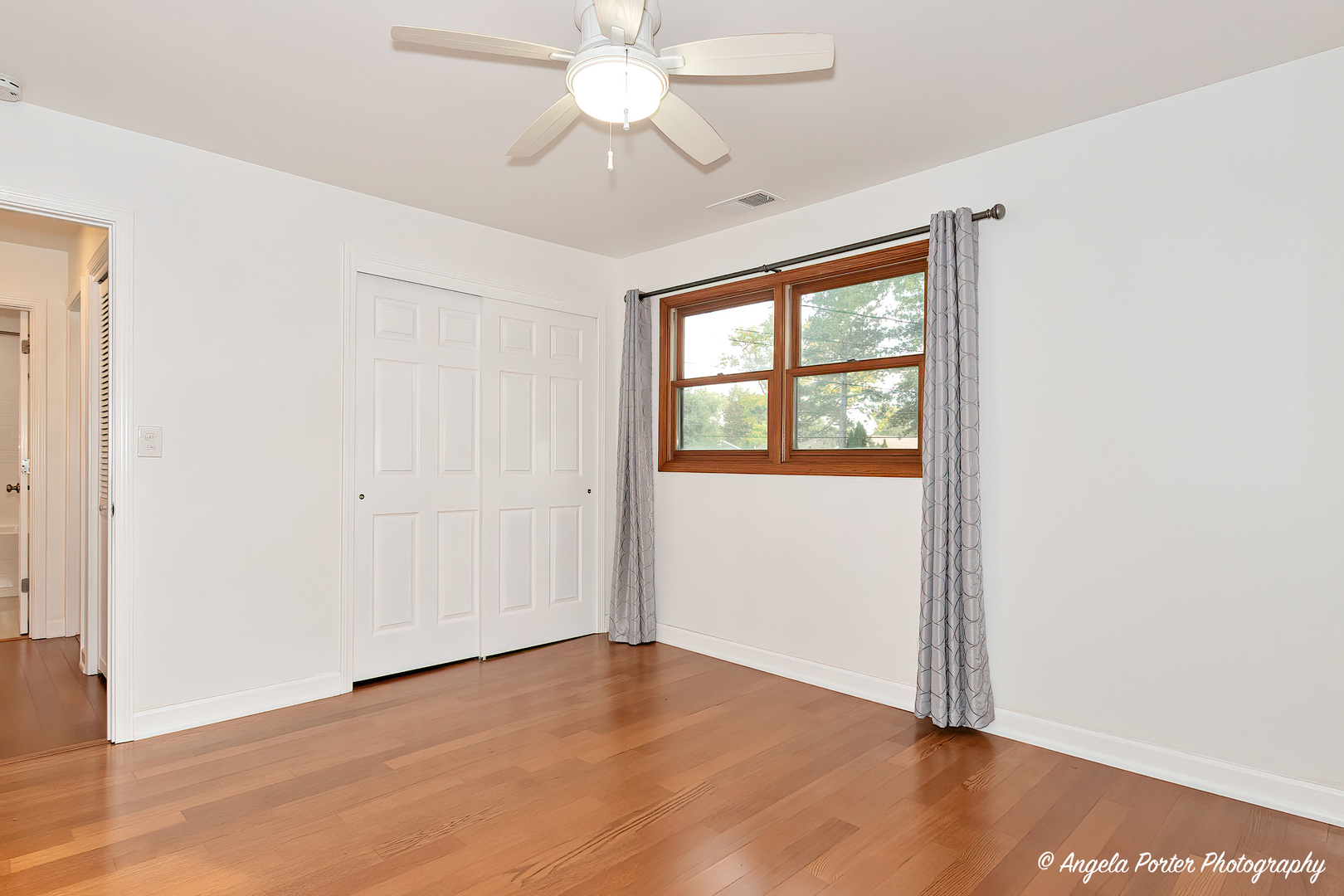7 Manor Road Lake Zurich, IL 60047 - Photo 18 of 27 an empty room with wooden floor fan and windows
