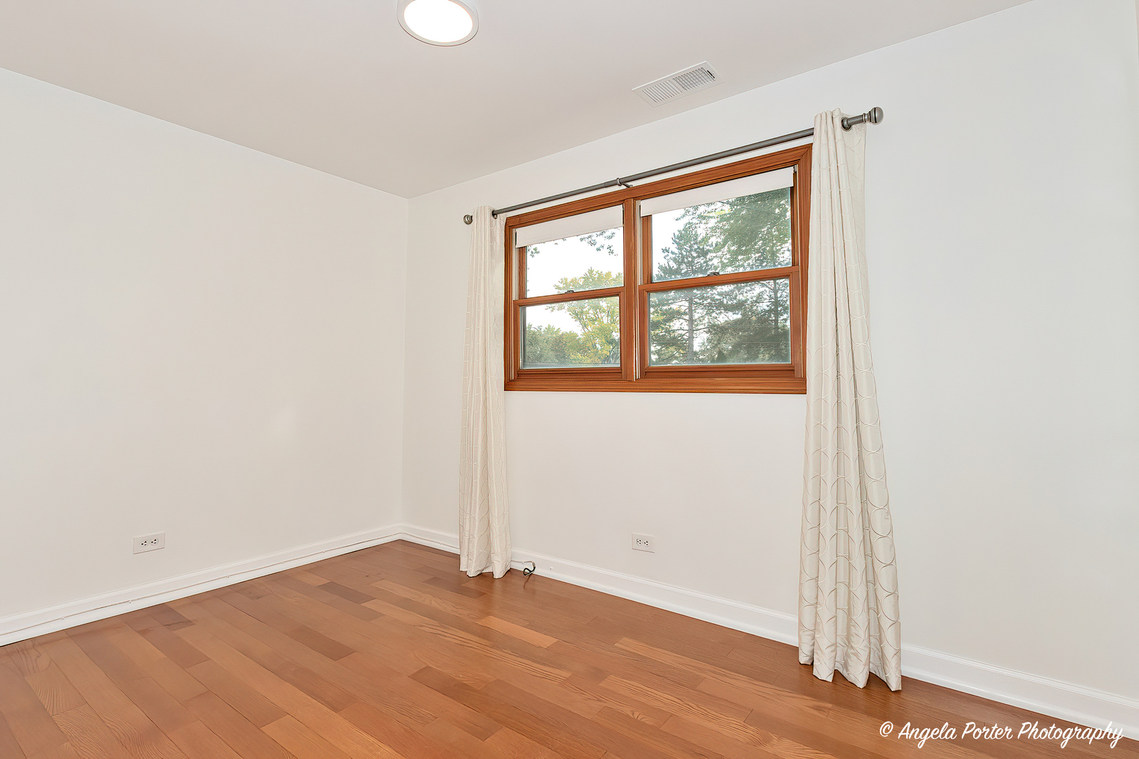7 Manor Road Lake Zurich, IL 60047 - Photo 20 of 27 an empty room with wooden floor and windows