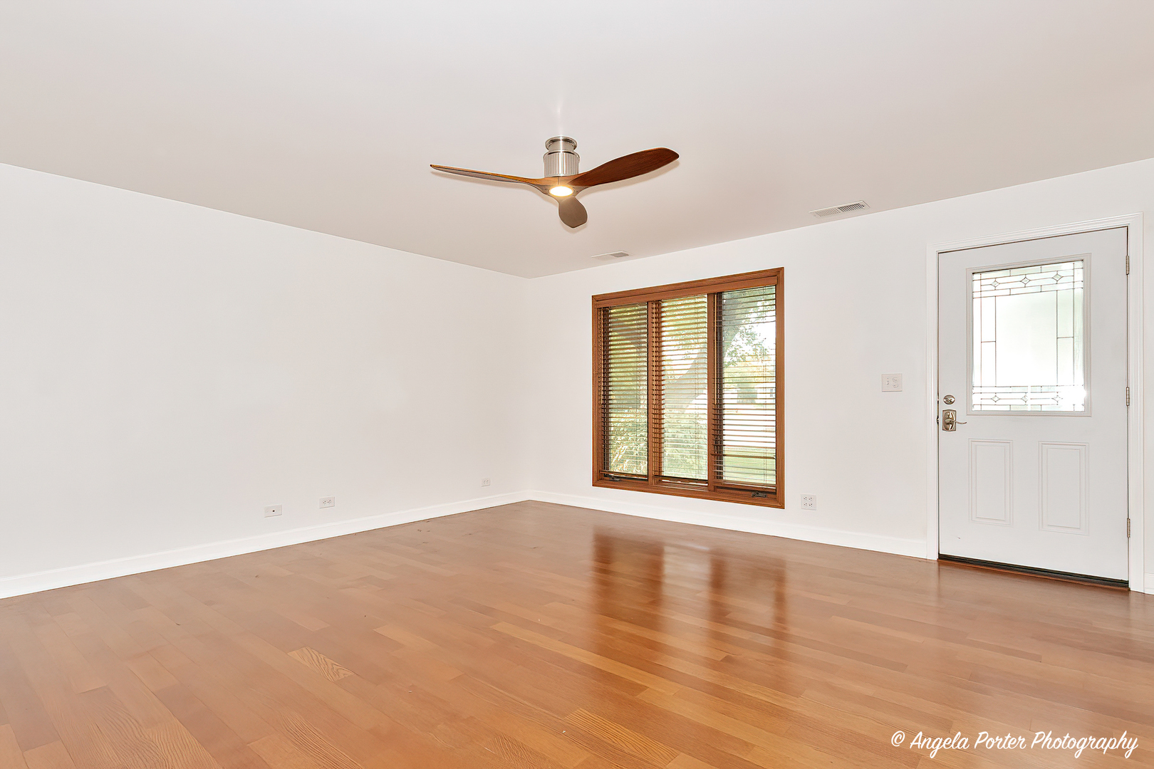 7 Manor Road Lake Zurich, IL 60047 - Photo 6 of 27 wooden floor in an empty room with a window