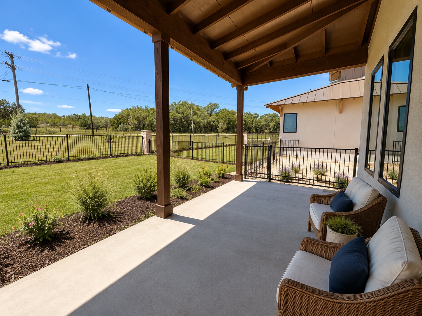 711 Paleface Ranch Road, Unit 4 Spicewood, TX 78669 - Photo 12 of 14 An inviting covered patio overlooks a private, fenced backyard with natural landscaping.