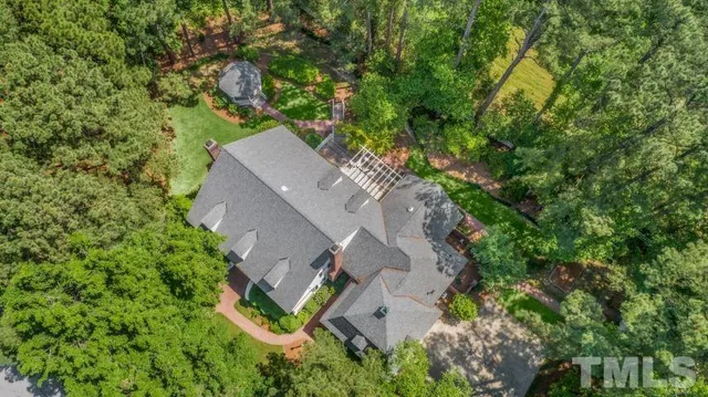an aerial view of a house with a yard