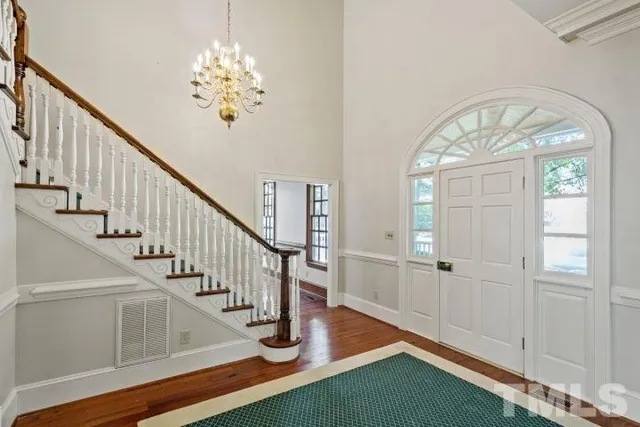 a view of entryway and hall with wooden floor