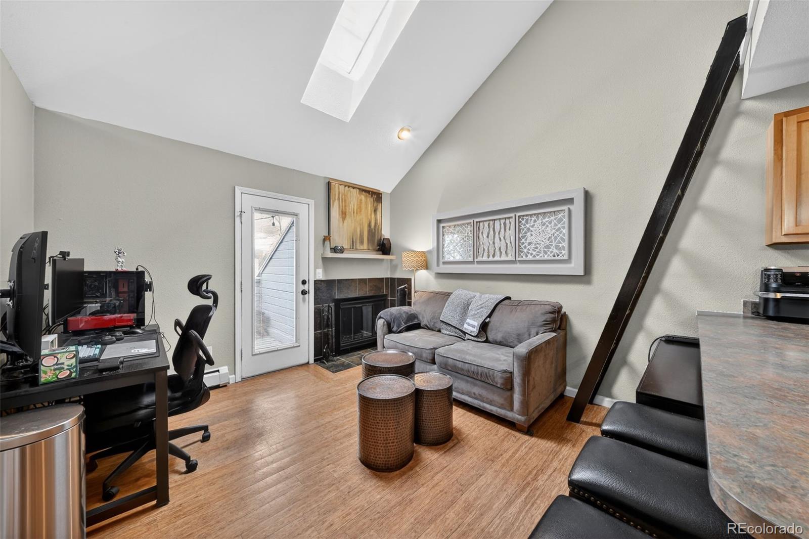 1405 Broadway, Unit 307 Boulder, CO 80302 - Photo 13 of 20 a living room with furniture and a fireplace