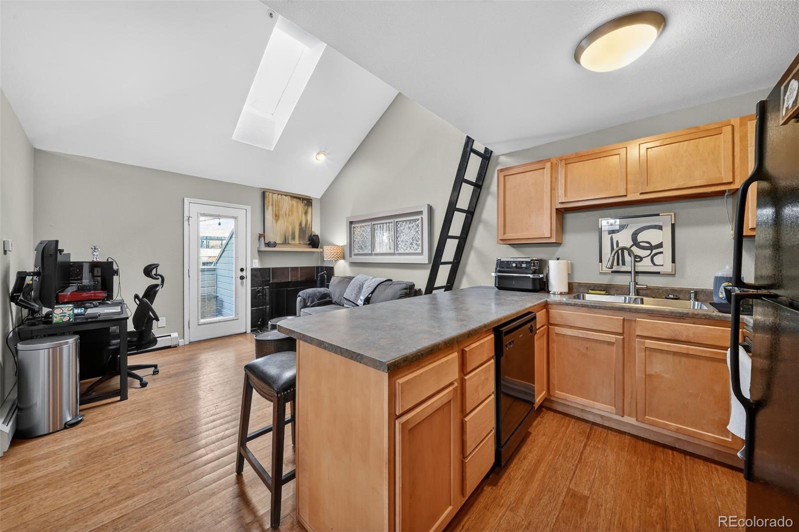 1405 Broadway, Unit 307 Boulder, CO 80302 - Photo 16 of 20 a kitchen with granite countertop a sink cabinets and wooden floor
