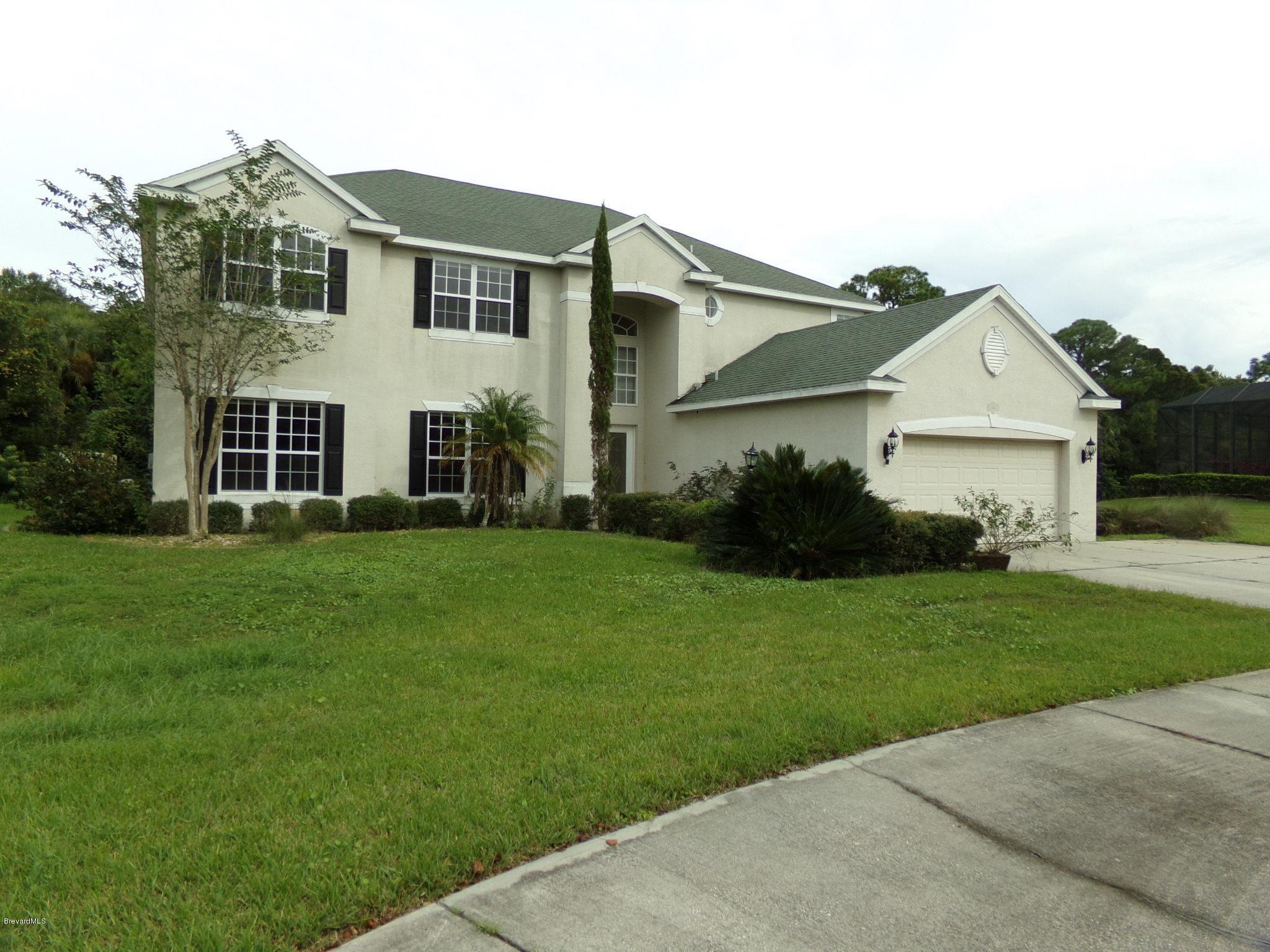 3995 Harlock Road Melbourne, FL 32934 - Photo 1 of 34 a front view of a house with garden