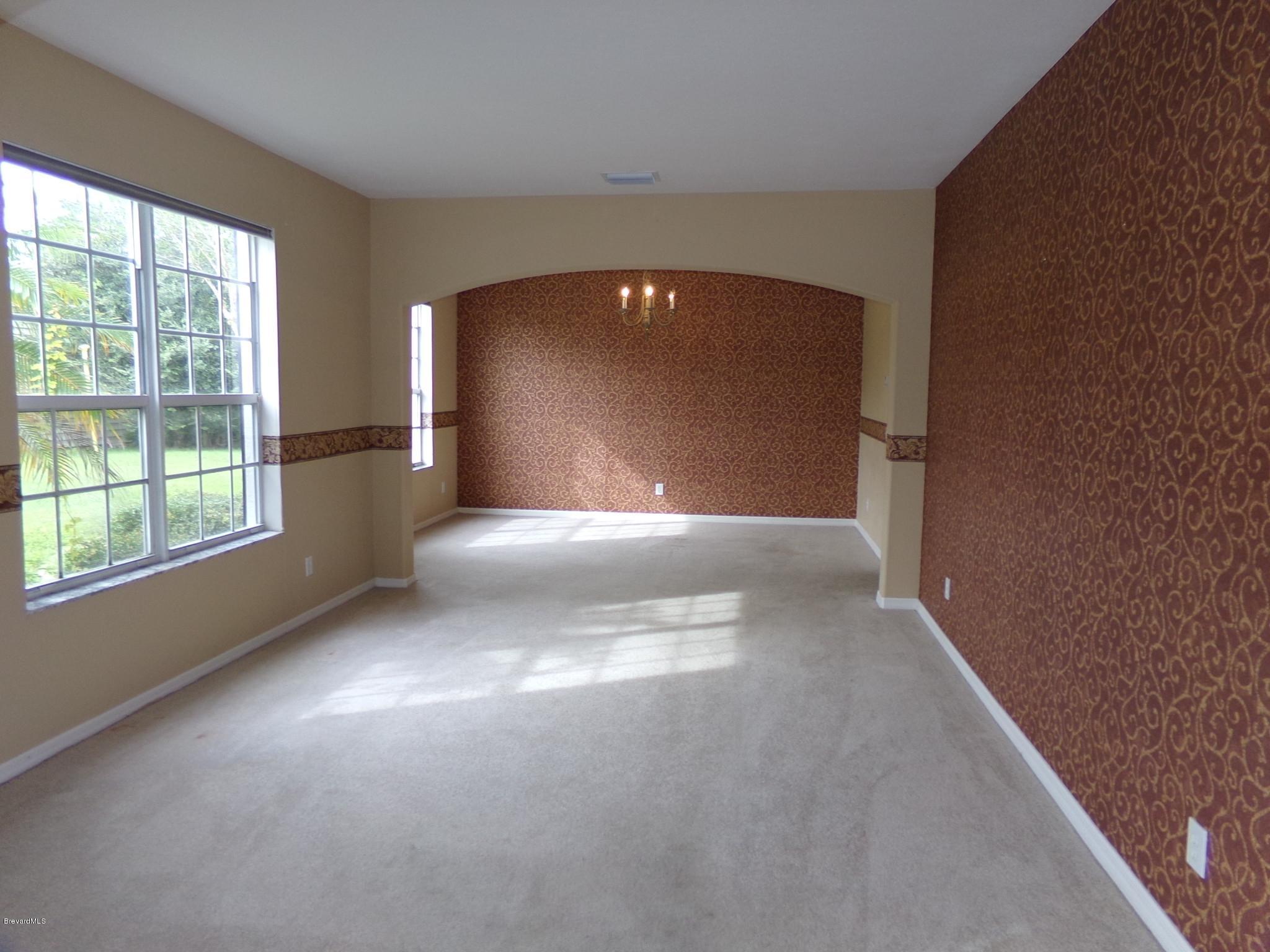 3995 Harlock Road Melbourne, FL 32934 - Photo 2 of 34 a view of a livingroom with a fireplace