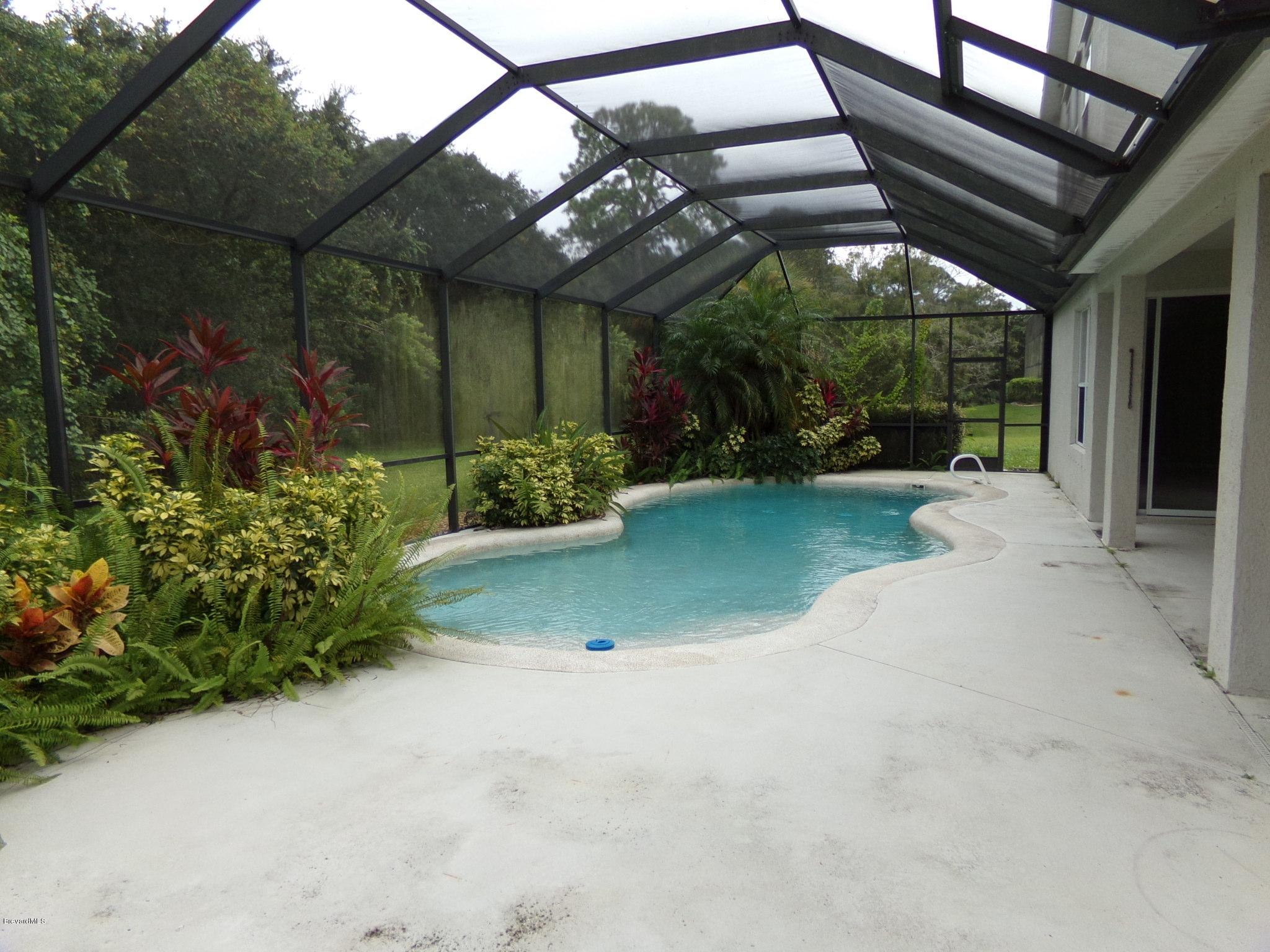 3995 Harlock Road Melbourne, FL 32934 - Photo 14 of 34 a view of a backyard with plants