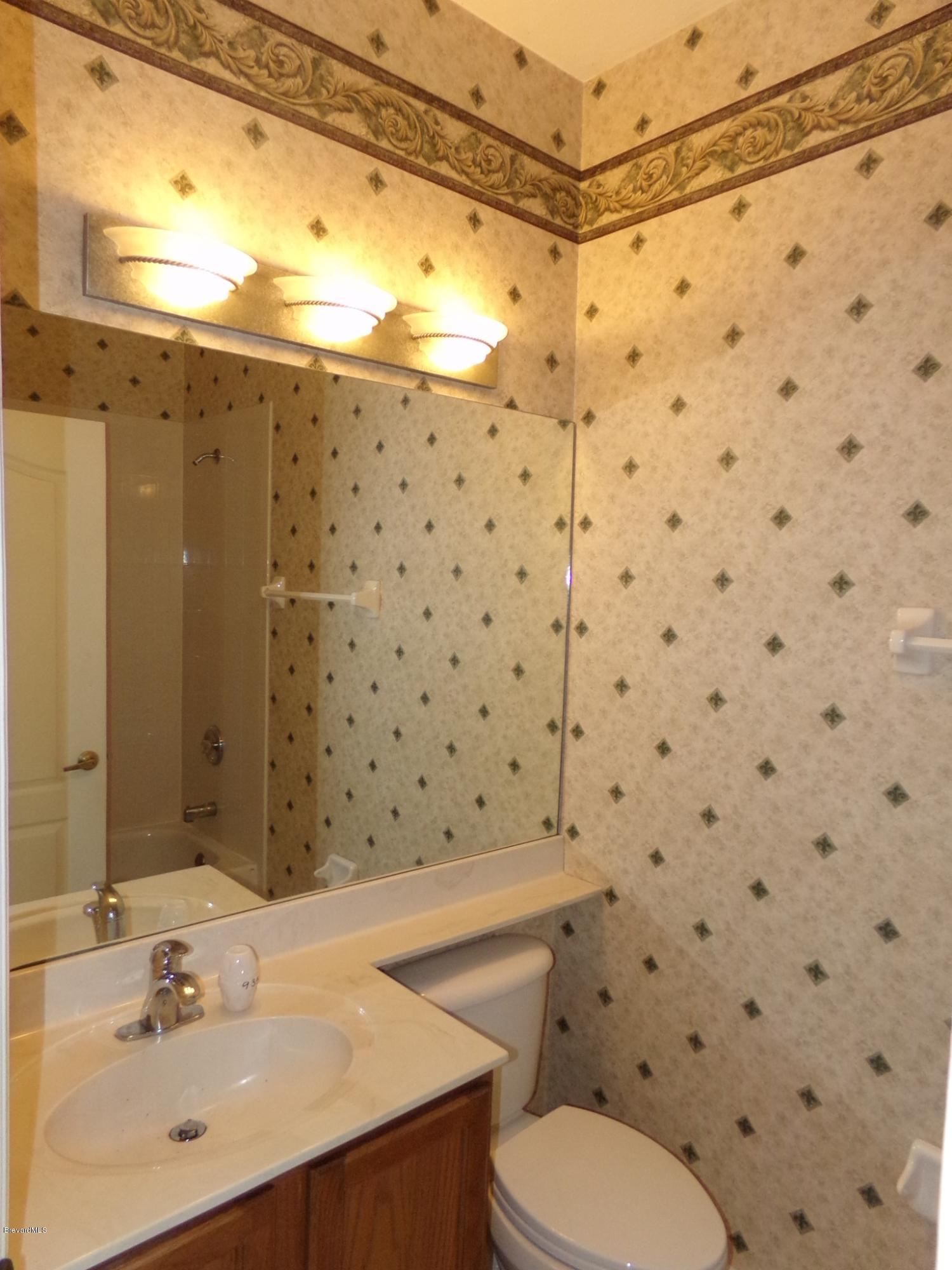 3995 Harlock Road Melbourne, FL 32934 - Photo 20 of 34 a bathroom with a sink toilet and shower