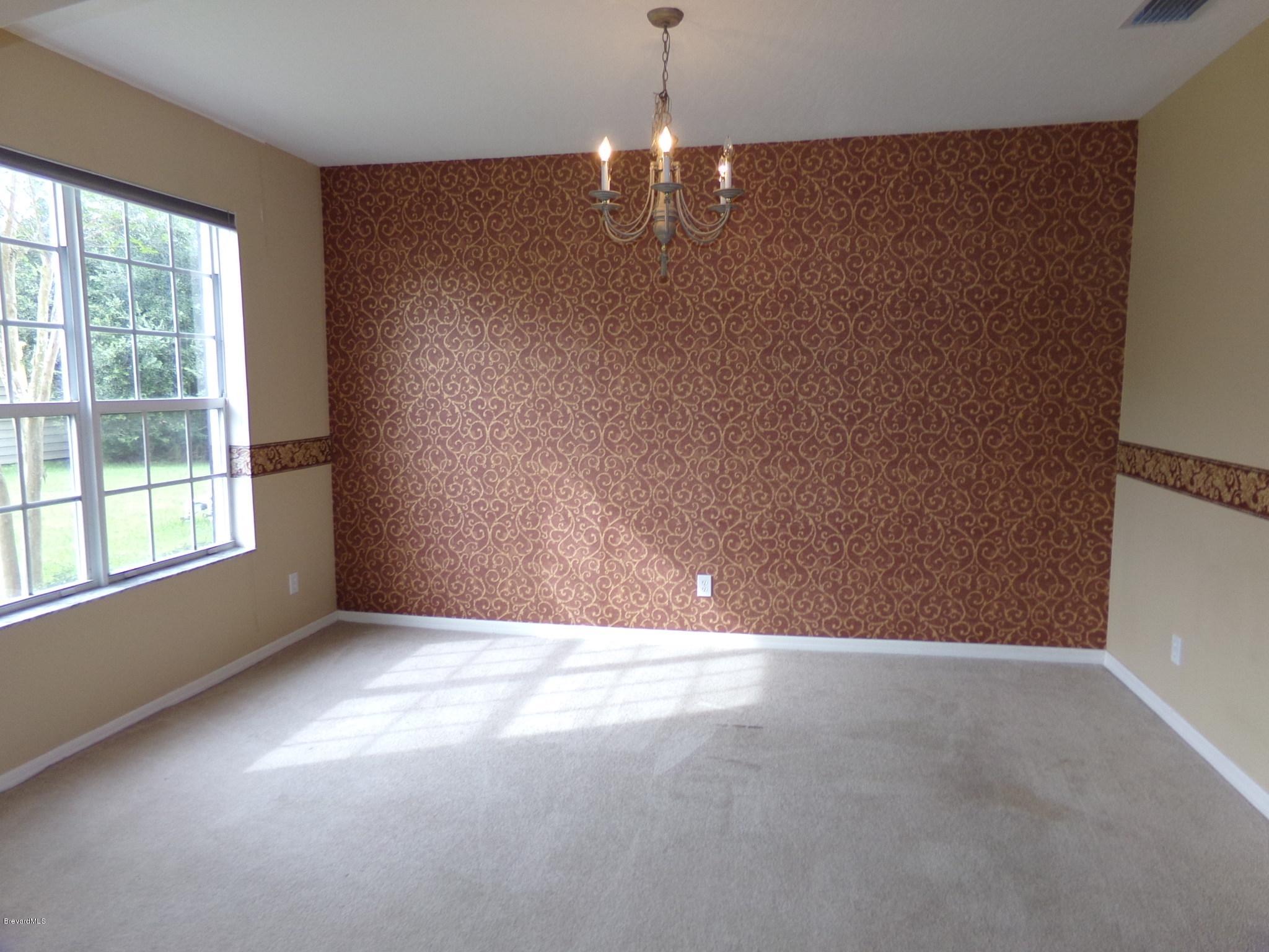 3995 Harlock Road Melbourne, FL 32934 - Photo 3 of 34 a view of an empty room with a window